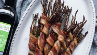 Bacon wrapped asparagus on white plate