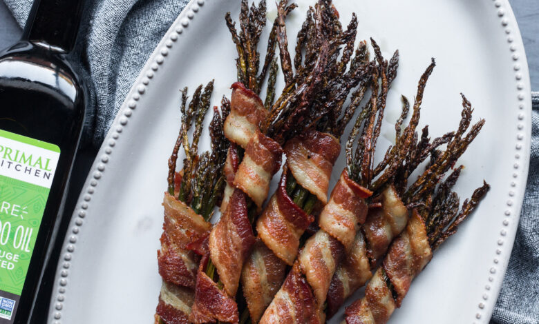 Bacon wrapped asparagus on white plate