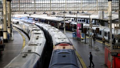 FILE PHOTO: A view of trains on the platform at Waterloo Station as a station worker stands nearby, on the first day of national rail strike in London, Britain, June 21, 2022. REUTERS/Henry Nicholls//File Photo