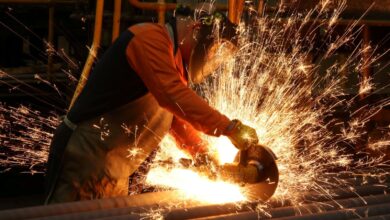 A worker cuts newly manufactured bars of steel at the United Cast Bar Group's foundry in Chesterfield, Britain, April 12, 2022