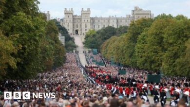 A funeral procession strewn with flowers arrives at Windsor Castle