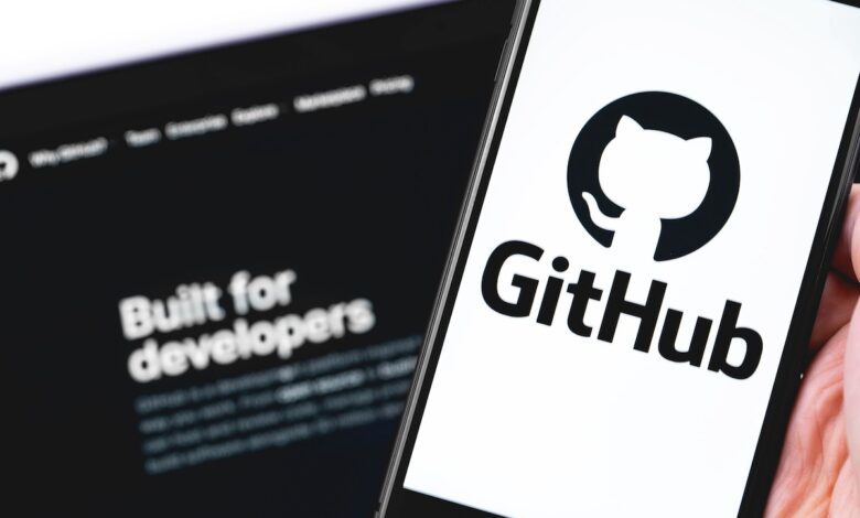 GitHub logo on the screen smartphone and notebook closeup. GitHub is the largest web service for hosting and developing IT projects. Moscow, Russia - July 12, 2020