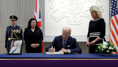 U.S. President Joe Biden signs a condolence book as U.S. first lady Jill Biden looks on after Queen Elizabeth, Britain's longest-reigning monarch and the nation's figurehead for seven decades, died aged 96, at the British Embassy, in Washington, U.S., September 8, 2022. REUTERS/Evelyn Hockstein