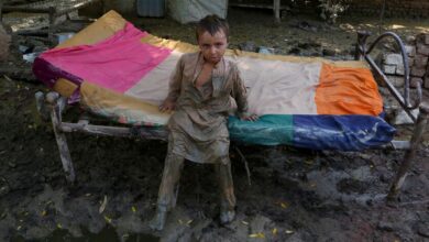 A boy stands in mud in Charsadda, Pakistan. Pic: AP