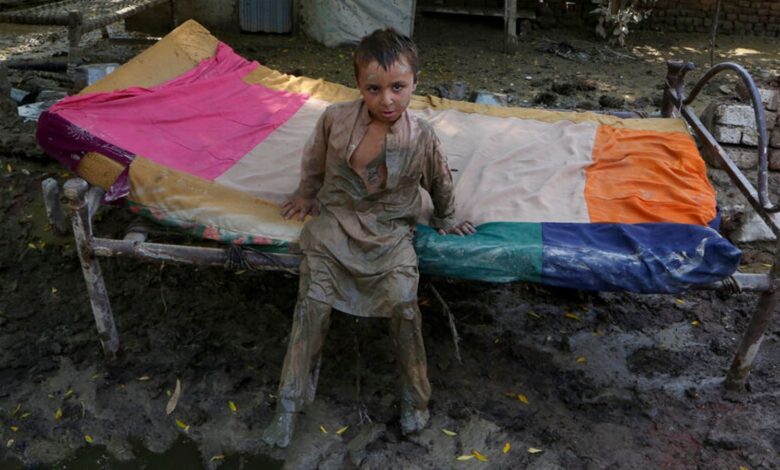 A boy stands in mud in Charsadda, Pakistan. Pic: AP