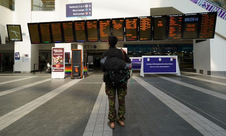 A passenger looks at message boards at Birmingham New Street Station, as members of the Rail, Maritime and Transport union (RMT) take part in a fresh strike over jobs, pay and conditions. Picture date: Wednesday July 27, 2022.