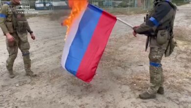 Ukrainian soldiers burn a Russian flag, amid Russia's invasion of Ukraine, in Vovchansk, Ukraine in this image from a video released September 13, 2022. State Border Service of Ukraine/Handout via REUTERS THIS IMAGE HAS BEEN SUPPLIED BY A THIRD PARTY MANDATORY CREDIT