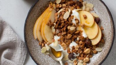 Muesli, apples, pears and yogurt in rustic plate. Healthy breakfast concept. Flat lay. Copy space