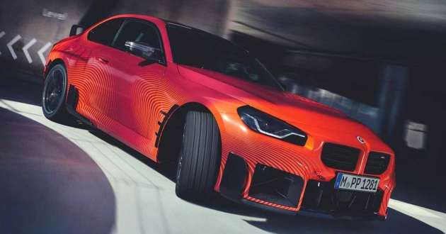 2023 BMW M2 with M Performance Parts - stacked exhaust pipes, lots of carbon fiber, large rear spoiler