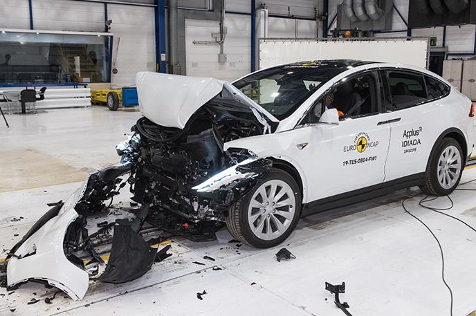 Why does Tesla modify cars just before crash testing in the lab?
