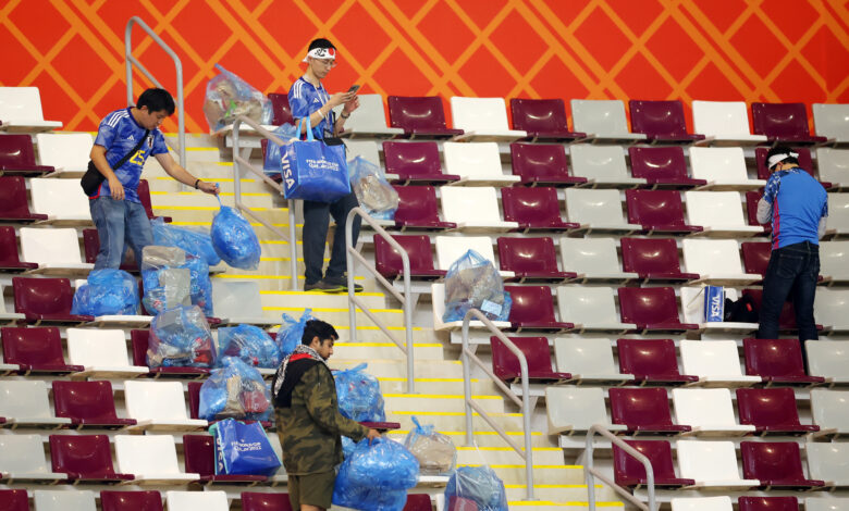 Japanese fans clear garbage from the stands after the Germany and Japan match at Khalifa International Stadium in Doha, Qatar on Wednesday.