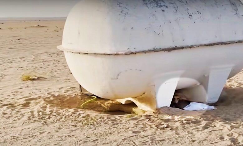 The object stirred beneath the water tank in the desert 122 degrees