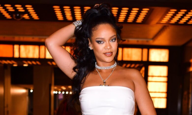 Rihanna shows off her pregnant belly in an all-white ensemble in a surprise appearance