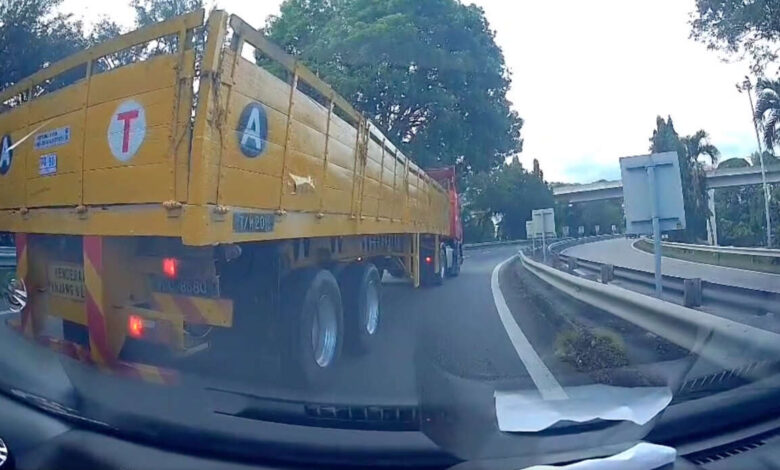 Lorry driver repeatedly attempts to drive into car, causes several near misses and obstructs traffic