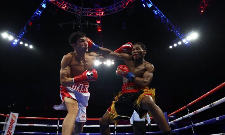 Raymond Ford defeated Otabek Kholmatov in the 12th round to win the WBA Featherweight title