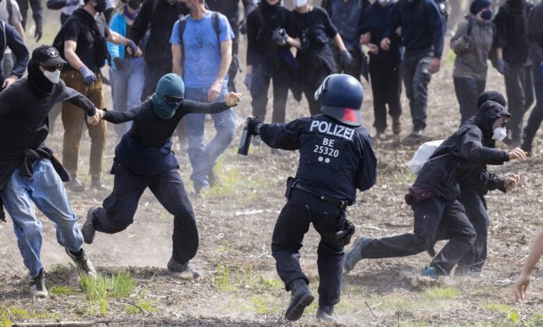 Protesters and police clash outside the German Tesla factory