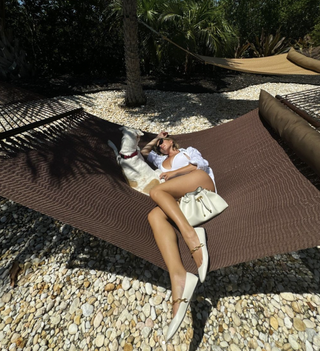 Sydney Sweeney lies in a hammock wearing a white swimsuit