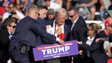 Photos show Trump with blood on his face on stage at rally